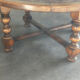 Vintage coffee table in turned wood and leather with astrological decoration.
