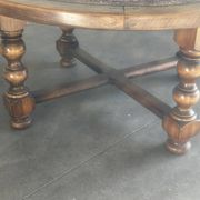 Vintage wooden turned coffee table with leather and astrological decoration.