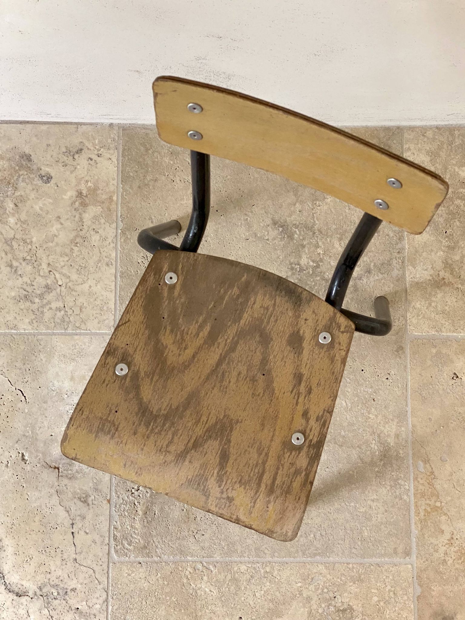 Vintage children's school chair in wood and black metal, industrial style.