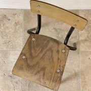 Vintage children's school chair in wood and black metal, industrial style.