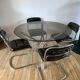 Set consisting of a table in chrome and smoked glass and its 4 tubular chairs in chrome and skaï a