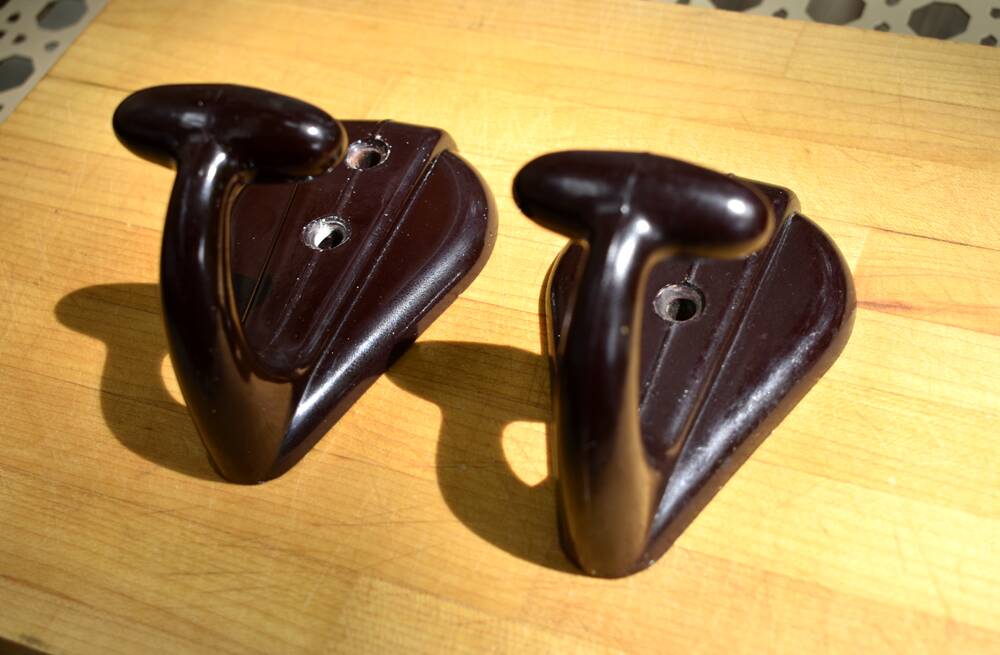 Pair of brown bakelite school hooks from 1957