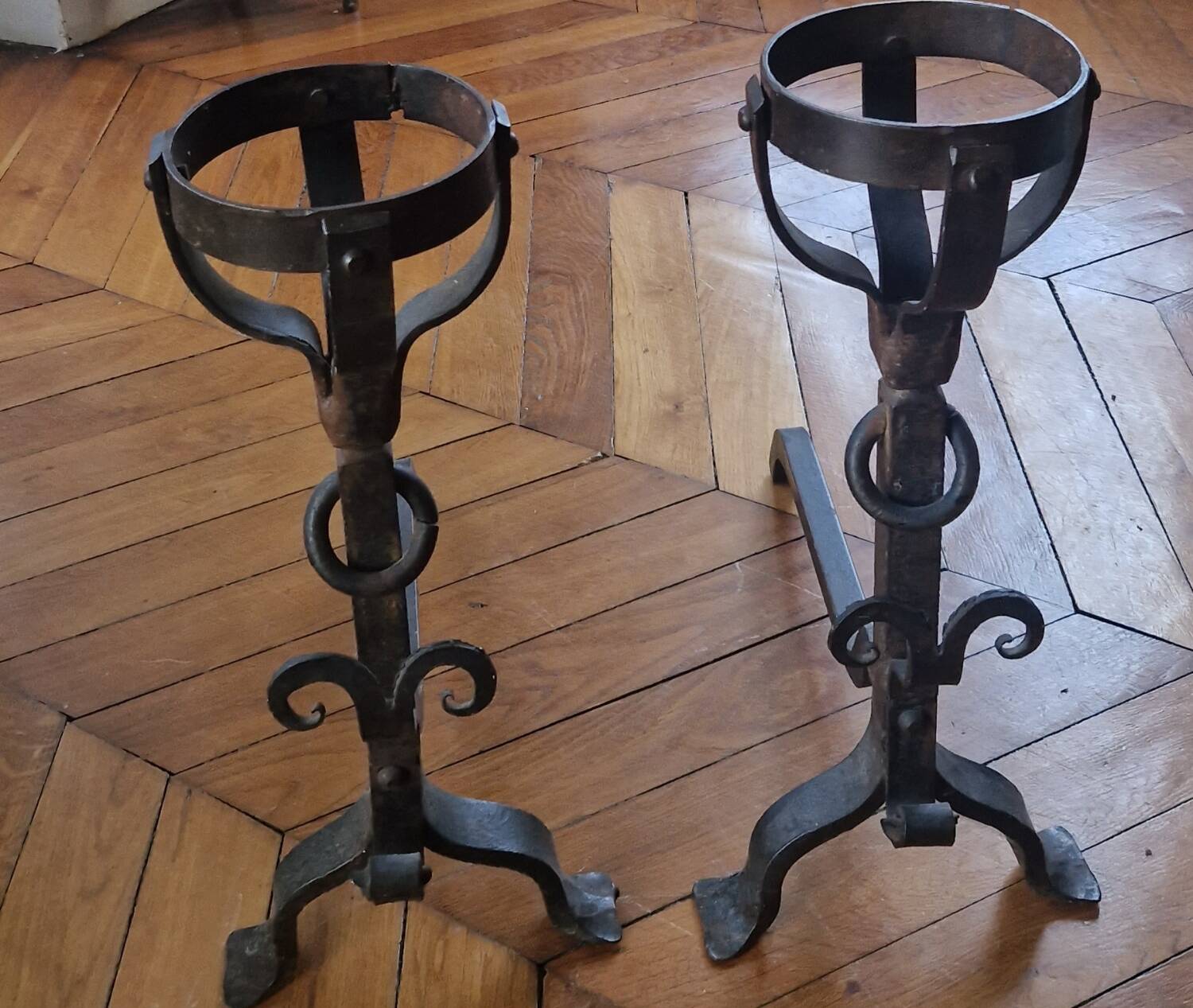 Pair of wrought iron andirons by Landier from the 17th century.