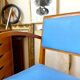 Bridge armchair in wood and blue skaï