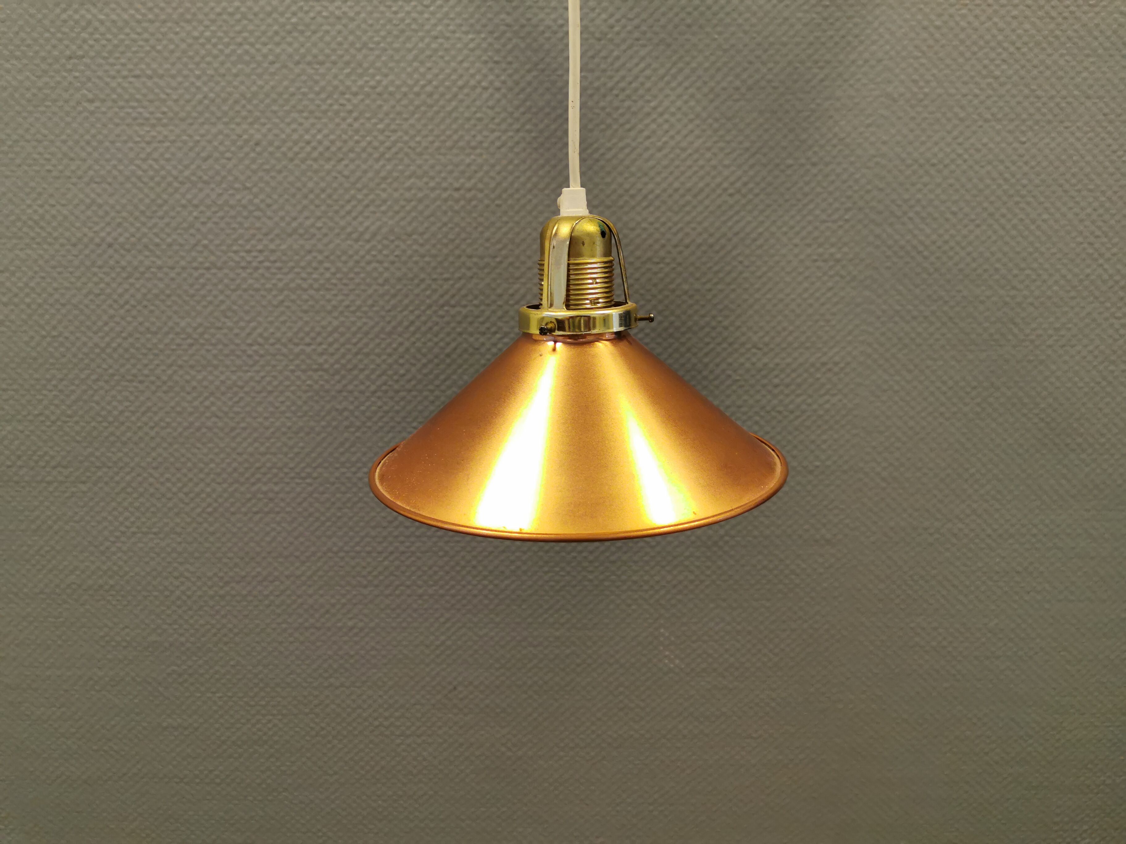 Copper hanging lamp with brass colored top and white inside lacquer.