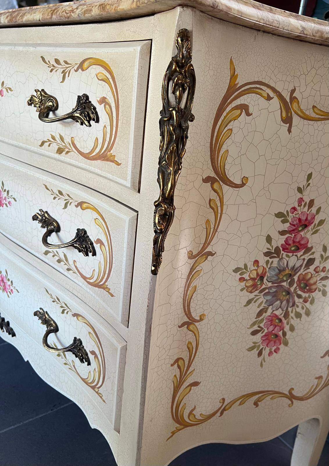 Curved Louis XV style commode in marble with painted floral decoration.