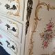 Curved Louis XV style commode in marble with painted floral decoration.