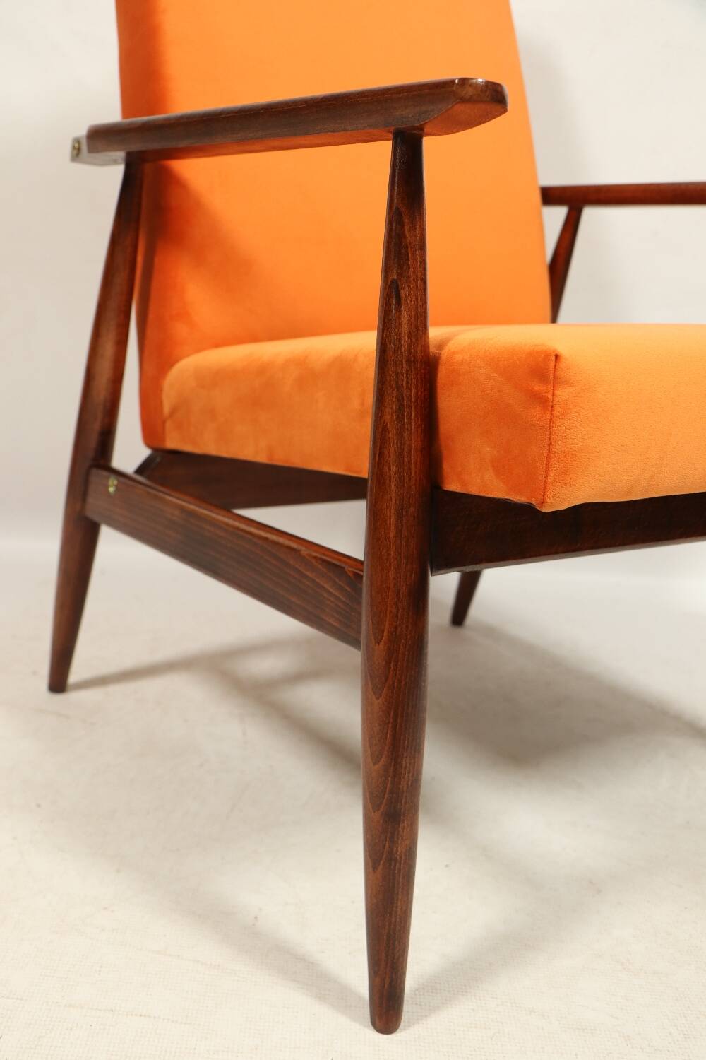 Modern armchair in orange papaya velvet with dark brown wood, 1970s Scandinavian style.