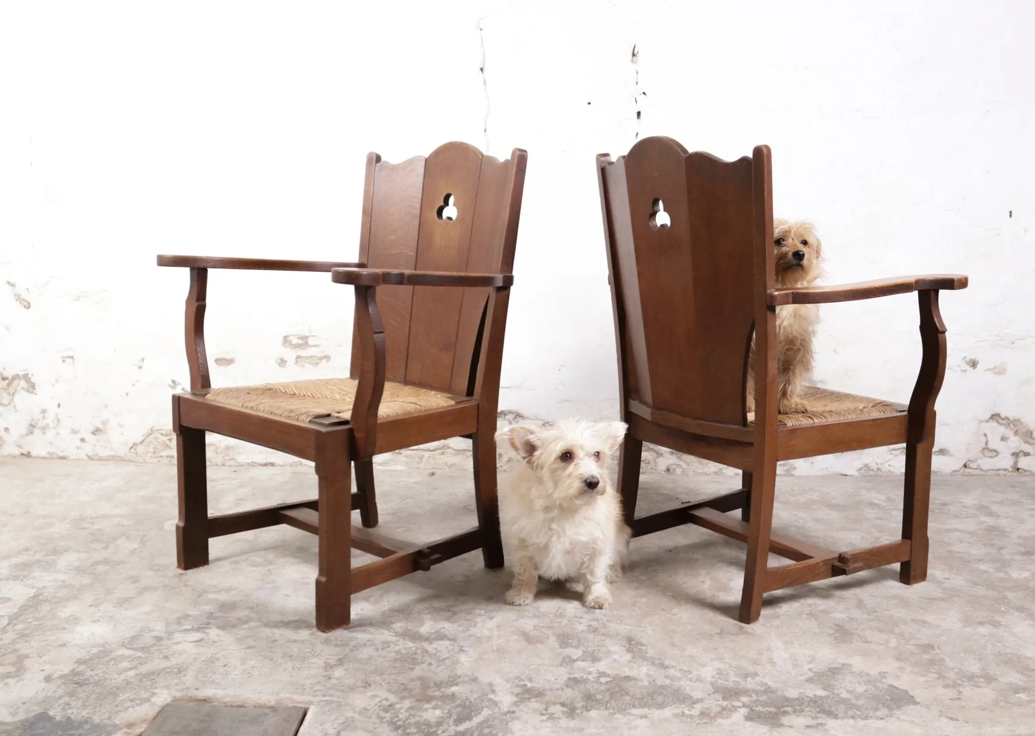Pair of brutalist oak lounge chairs with rush seats – Netherlands