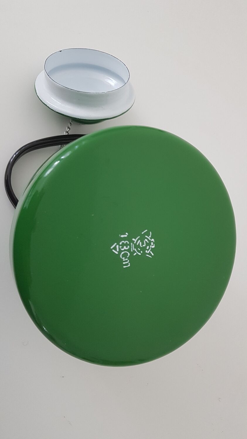 Old green kettle in enamelled metal