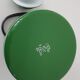 Old green kettle in enamelled metal