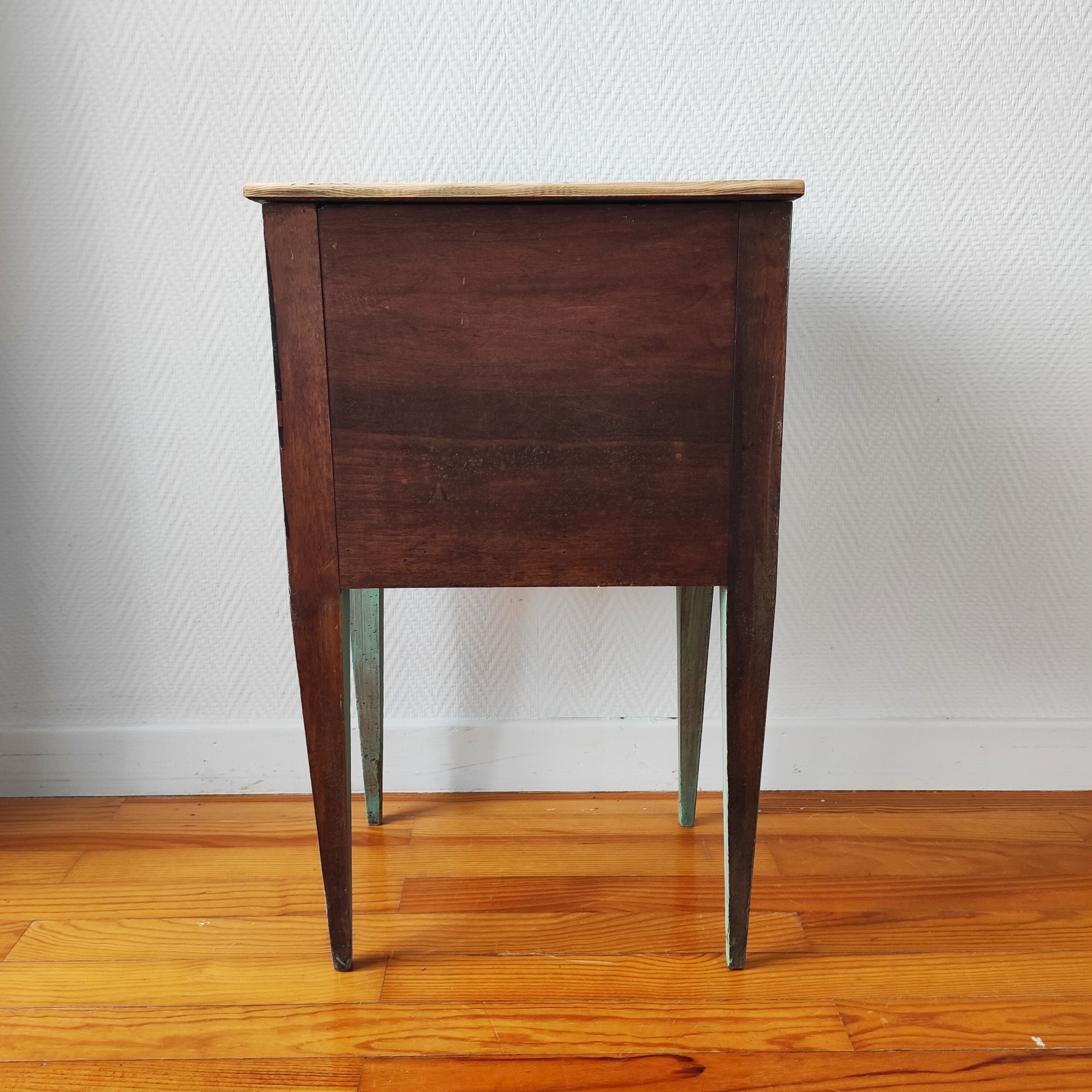 Patinated bedside table end of sofa