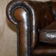 Restored leather Chesterfield sofa, walnut legs.