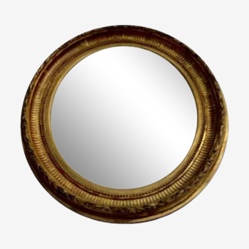 Oval wall mirror in gilded wood late nineteenth