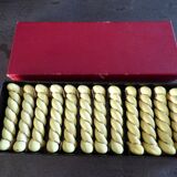 12 yellow and gold ceramic knife rests in their case from the 1950s.
