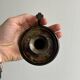 Small antique candle holder in patinated metal