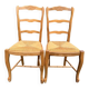 2 solid wood and rush-seated chairs in Louis XV style with shell carving from the 20th century.