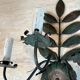 Pair of decorative wall sconces with sunflowers and patinated metal foliage.