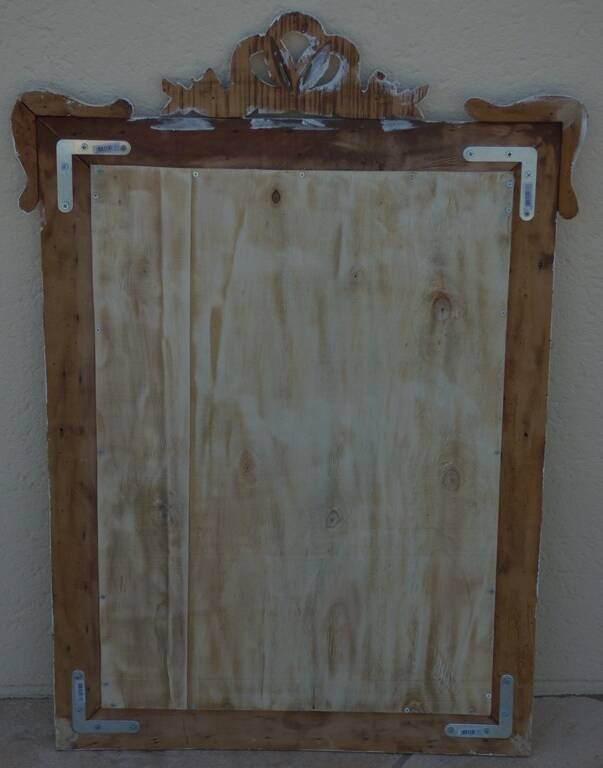 Chic and stylish old mirror with carved wooden frame in limed white and gold