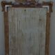 Chic and stylish old mirror with carved wooden frame in limed white and gold
