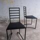 Set of 4 minimalist black steel dining chairs.