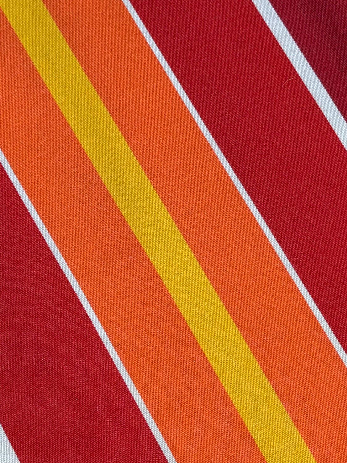 Vintage deck chair with red and orange striped fabric, original patina.