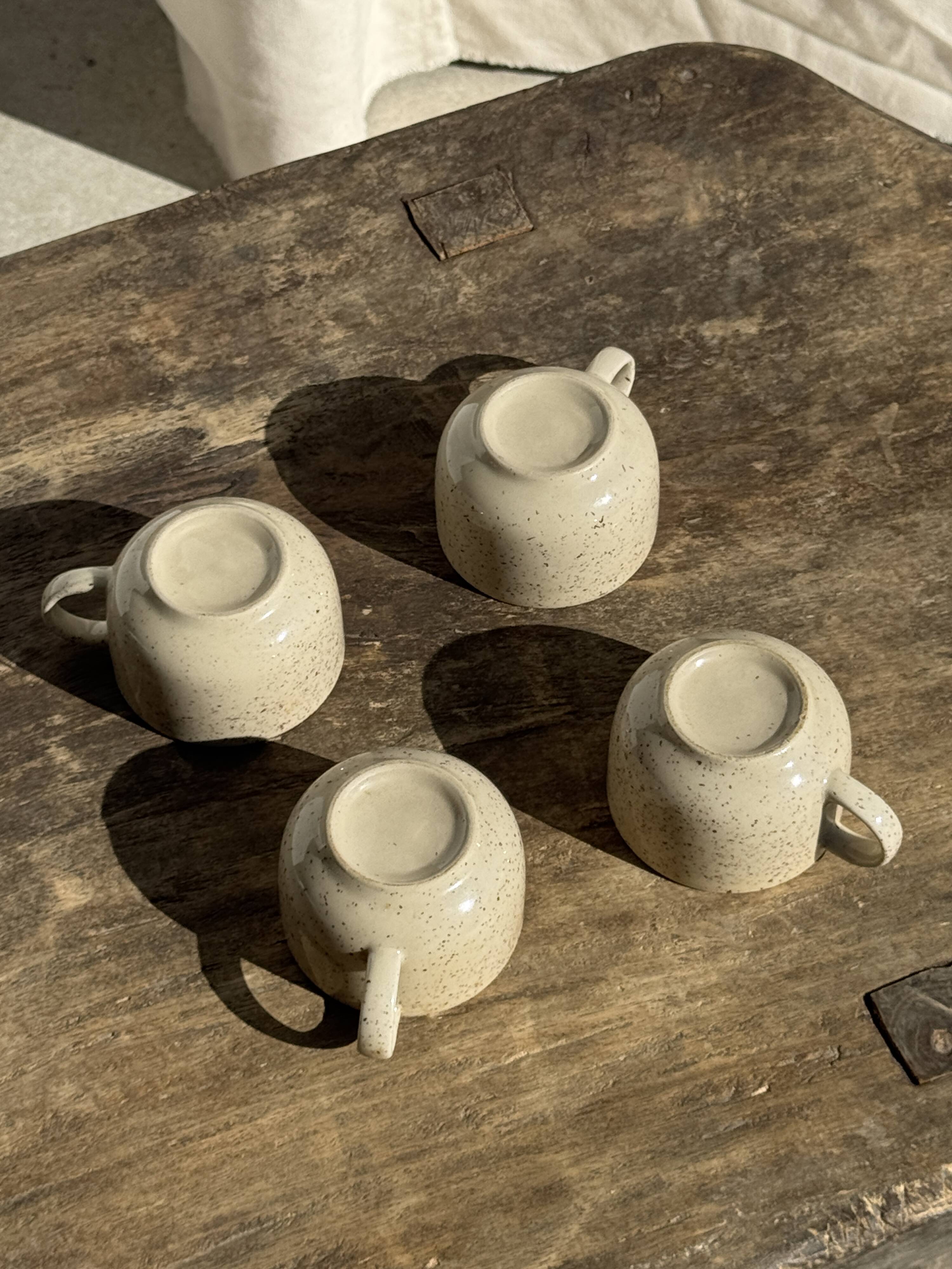 Set of 4 vintage speckled beige stoneware coffee cups.