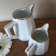 2 white porcelain milk jugs with platinum trim, Flora by Apilco.