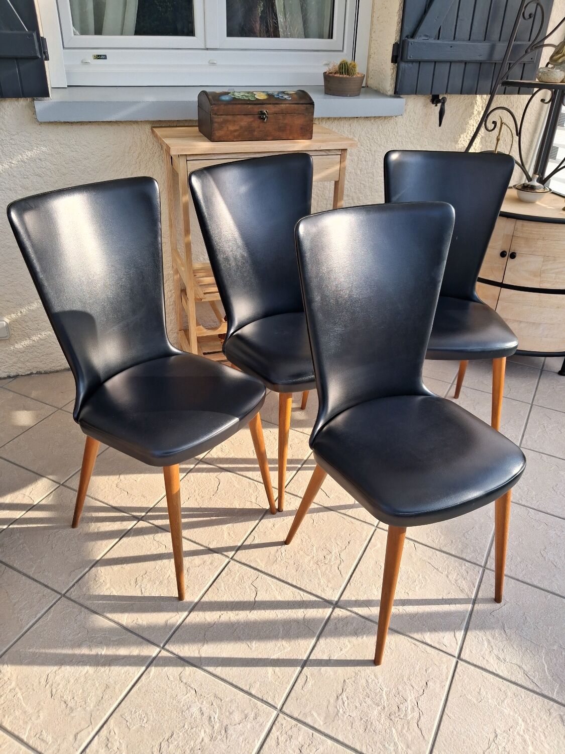 4 black Baumann style chairs