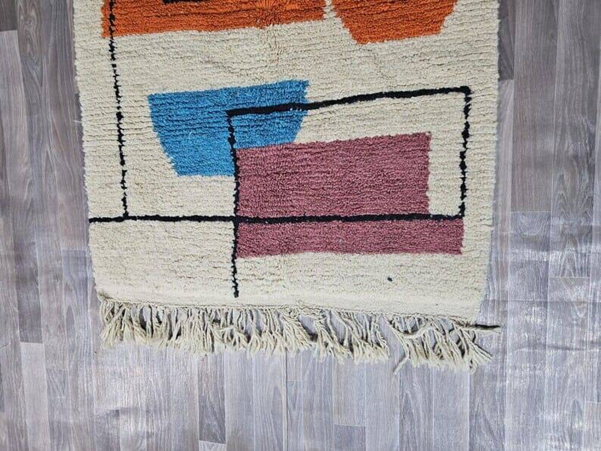 Traditional handmade wool Berber rug with colourful patterns.