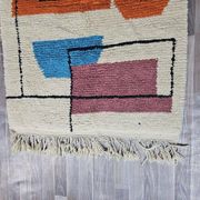 Traditional handmade wool Berber rug with colourful patterns.