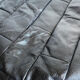 Patchwork black leather pouf de Sède