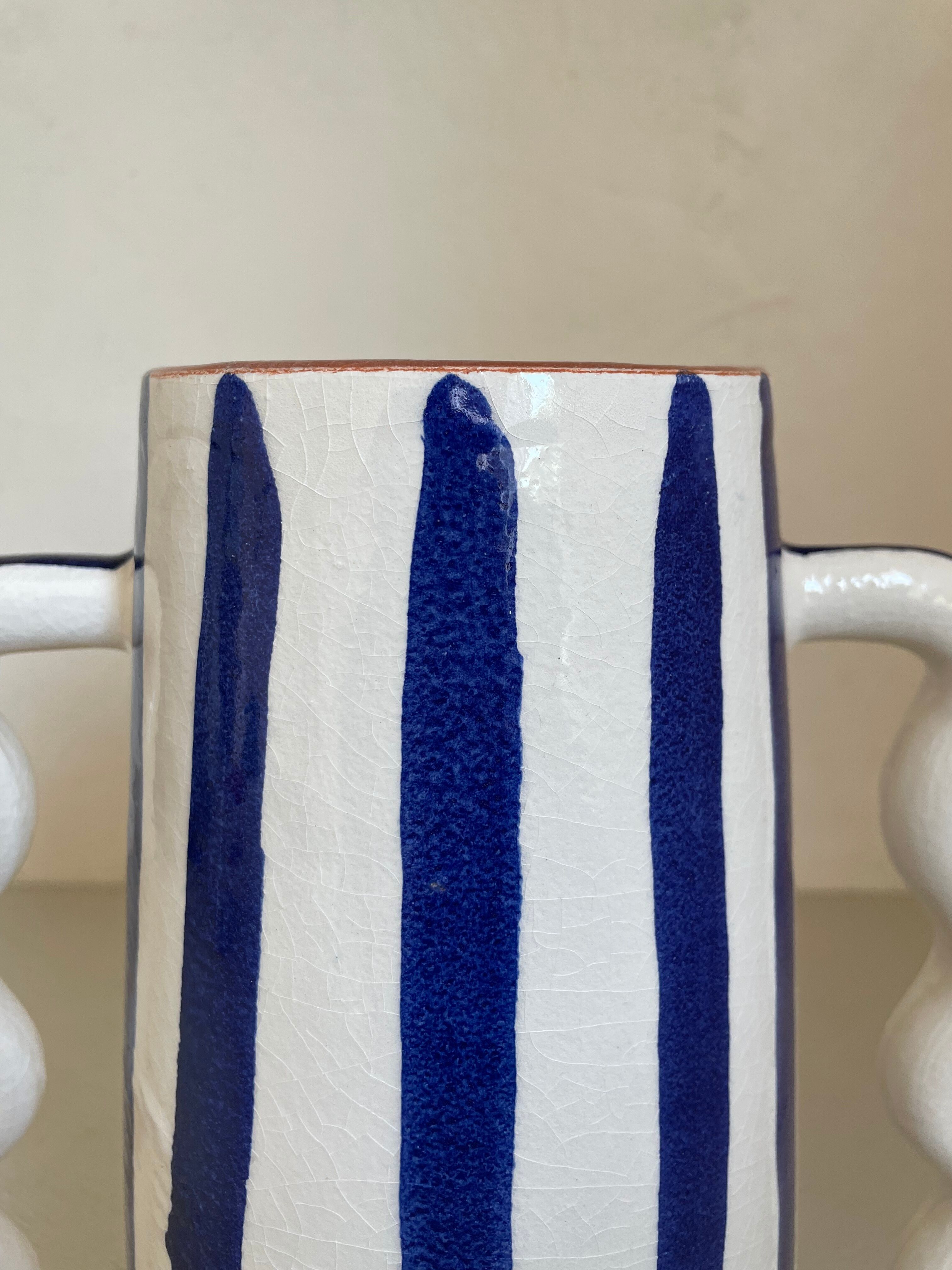 Klein blue and white striped ceramic vase with abstract handmade wavy handles