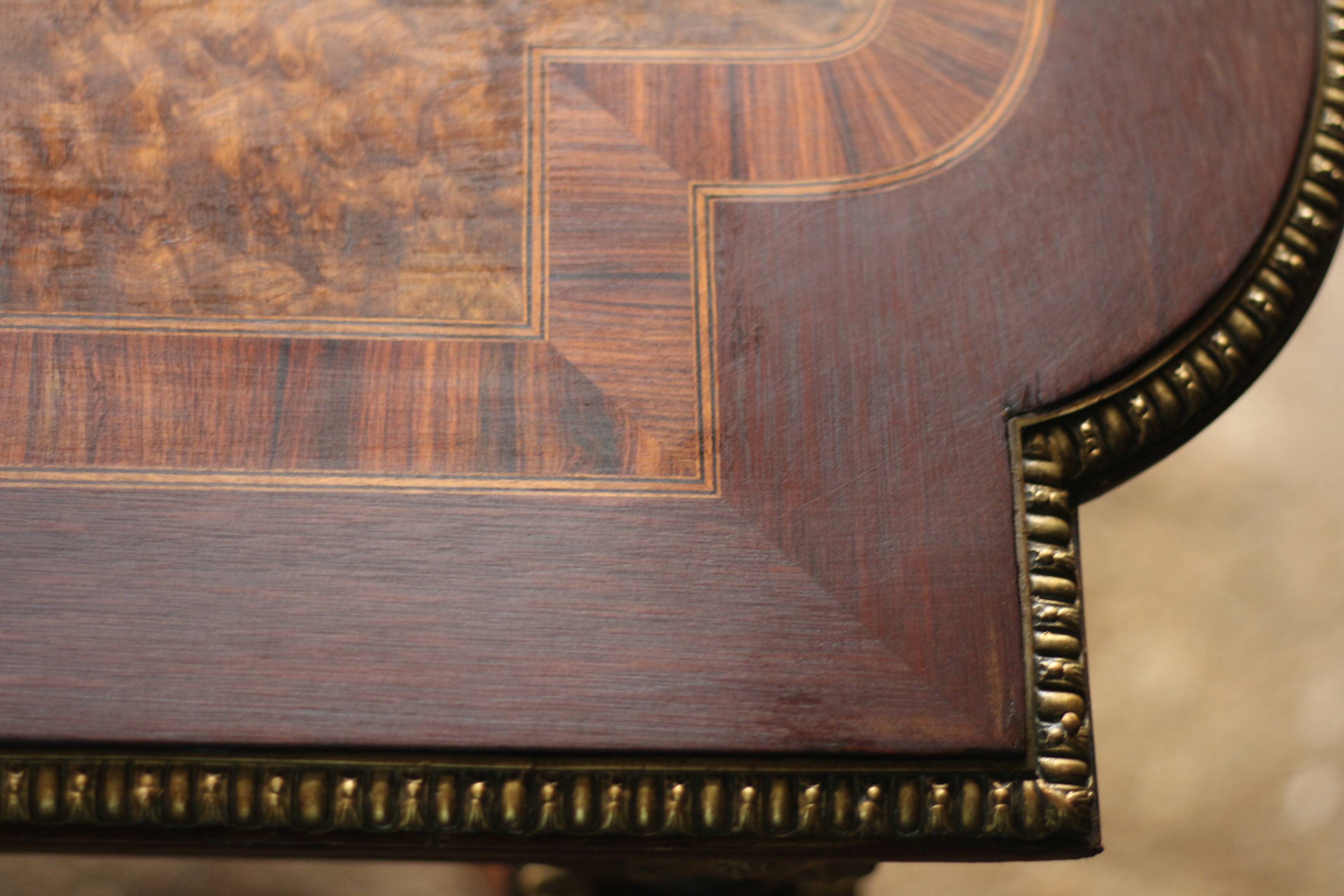 Superb Napoleon III table. Marquetry top and gilded bronzes.