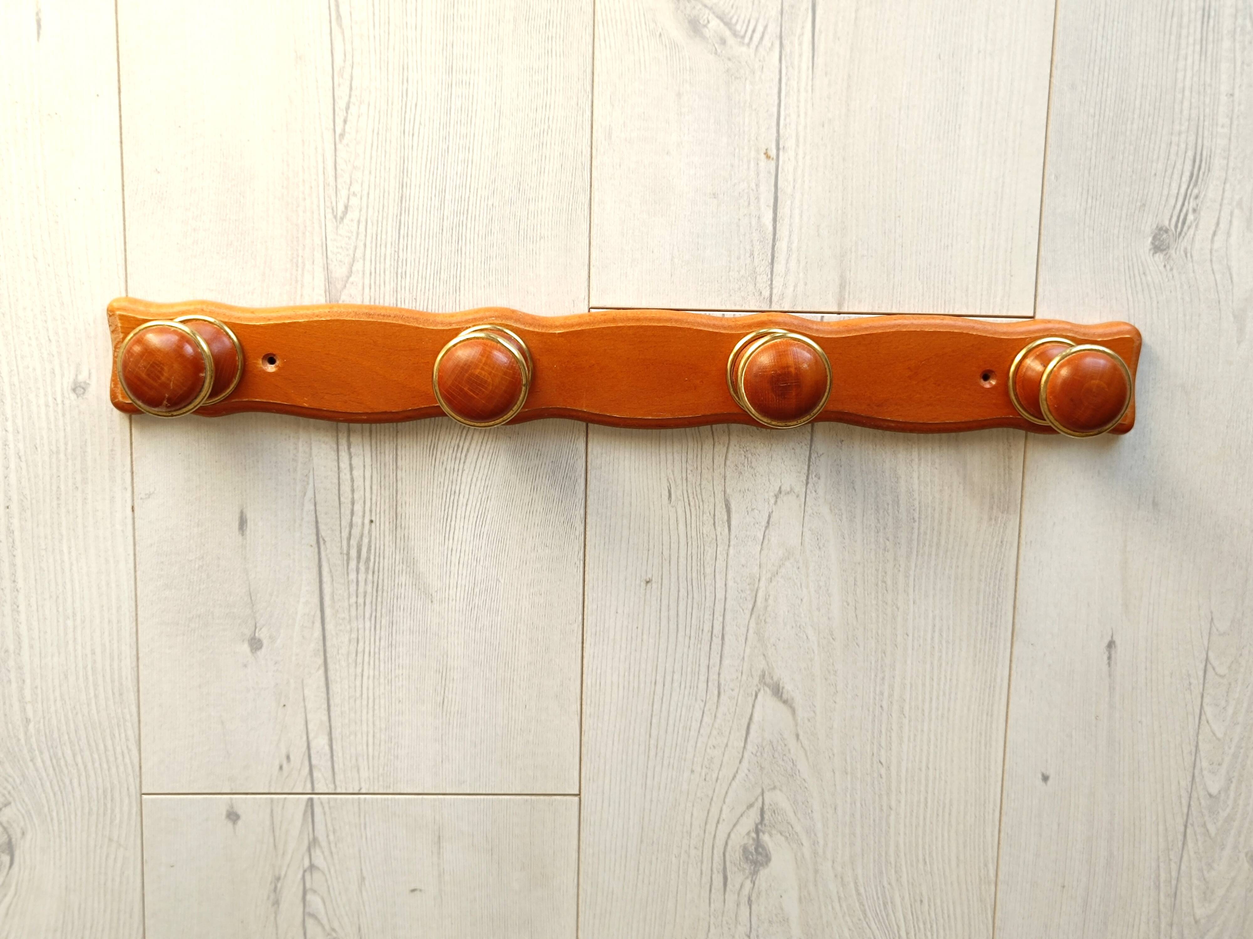 Wall-mounted coat rack in wood and brass