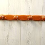 Wall-mounted coat rack in wood and brass