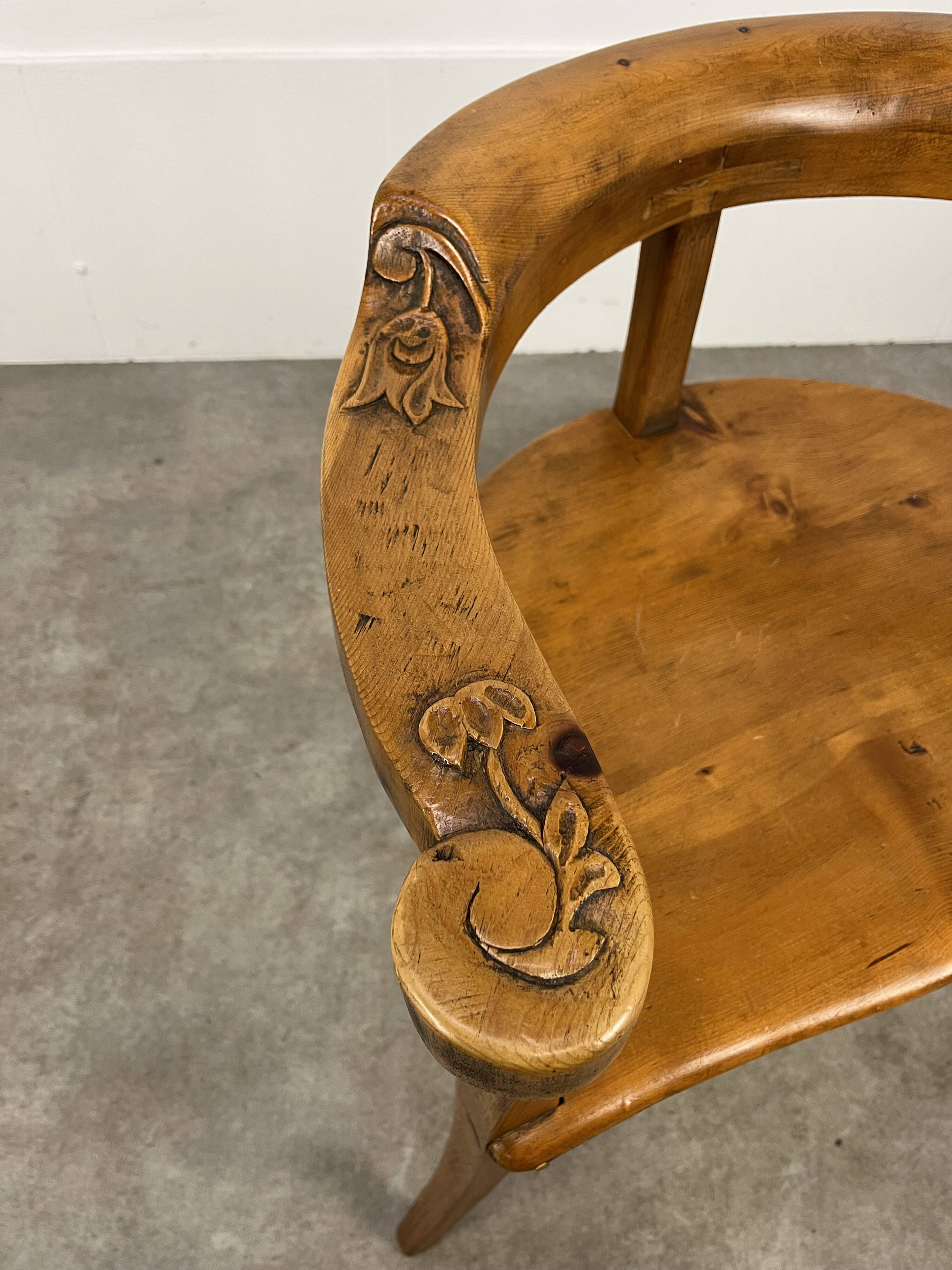 Chalet-style carved wooden tripod armchair