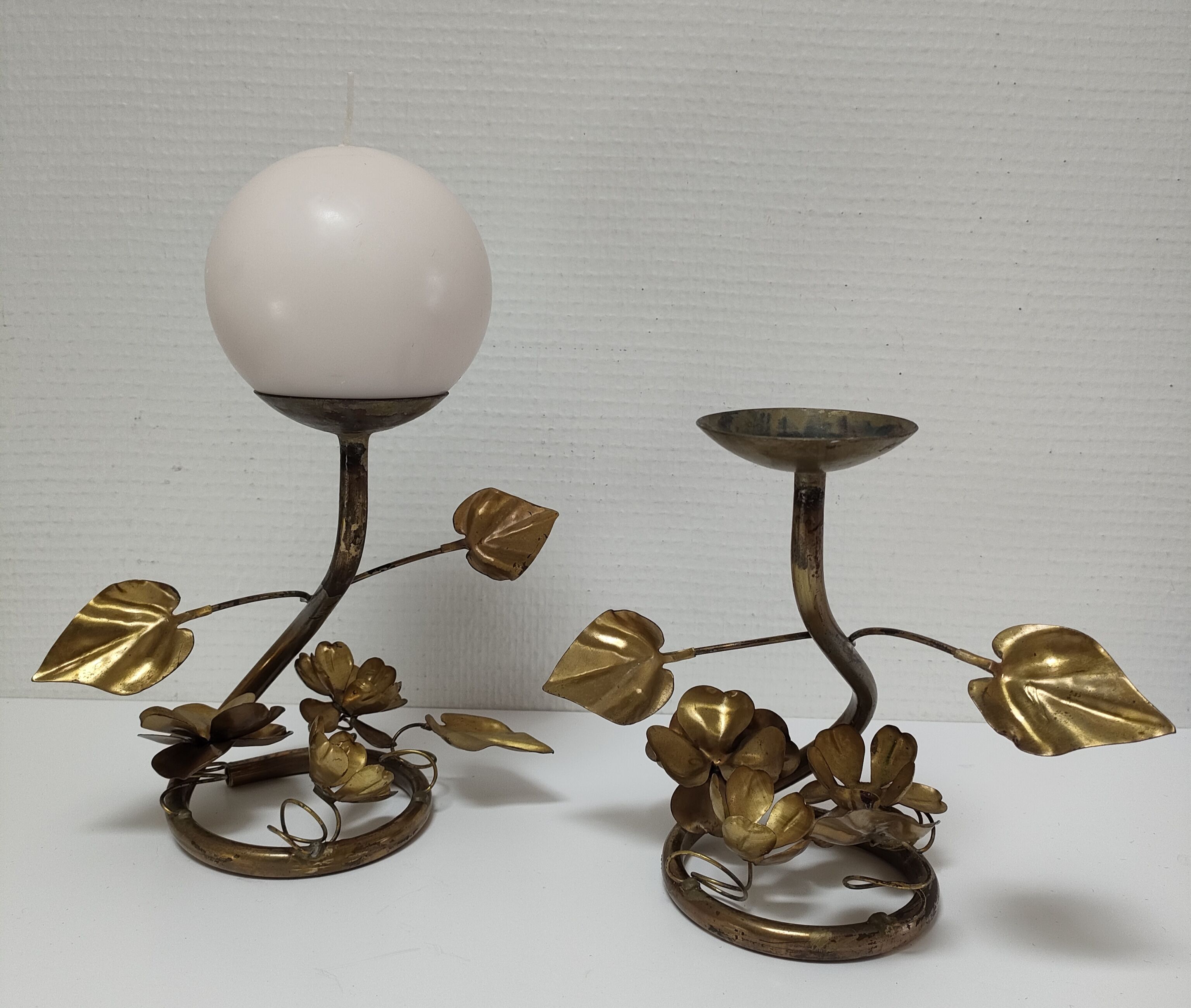 Pair of brass candle holders decorated with patinated metal flowers