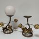 Pair of brass candle holders decorated with patinated metal flowers