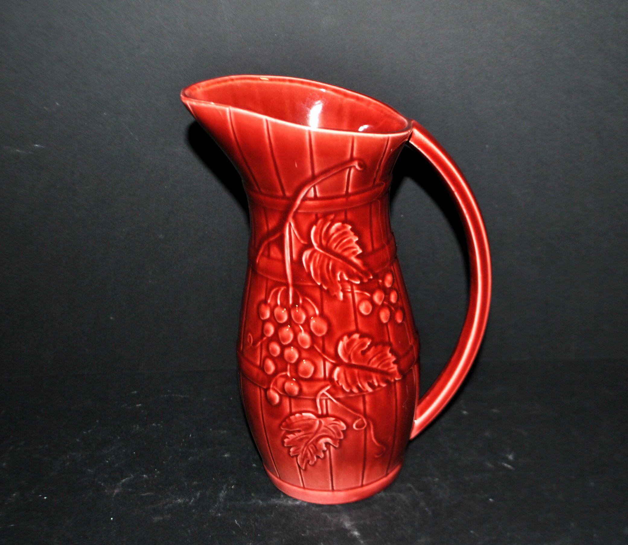 Sarreguemines wine jug in red slipware with grapevine decoration.