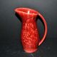 Sarreguemines wine jug in red slipware with grapevine decoration.