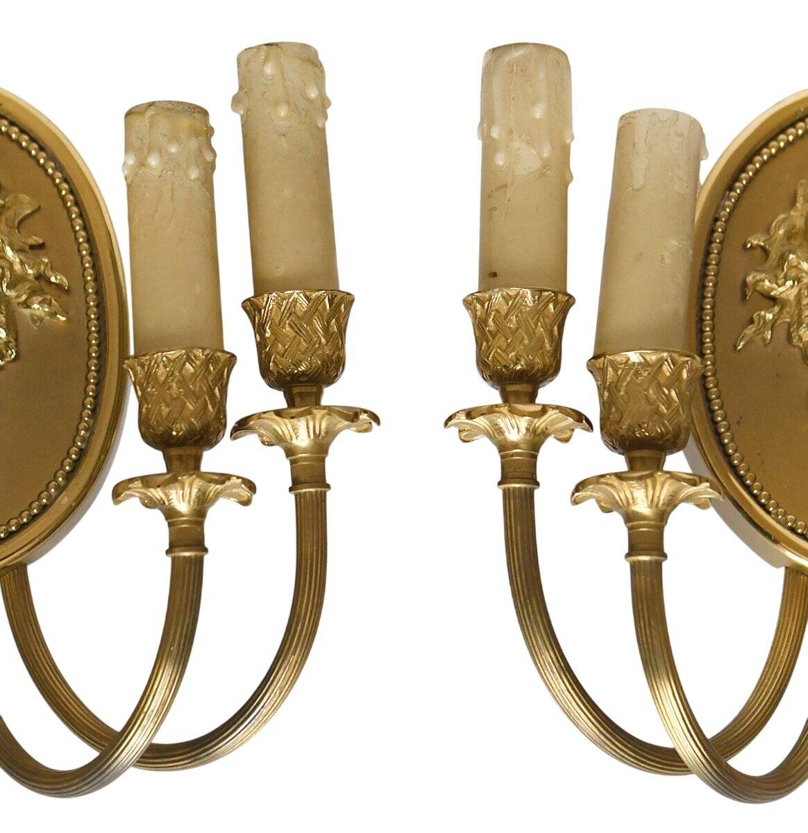 Pair of wall sconces with a relief decoration of a Bacchus mask.