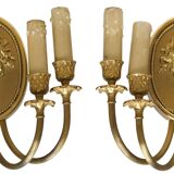 Pair of wall sconces with a relief decoration of a Bacchus mask.