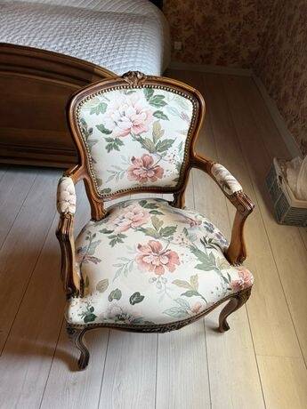 Louis XV style armchair upholstered in floral fabric.