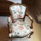 Louis XV style armchair upholstered in floral fabric.