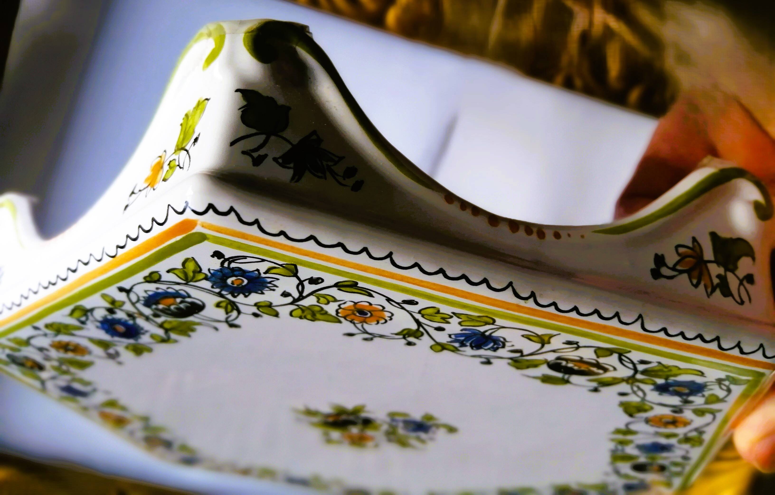 Hand-painted flat dish decorated in the Moustier style.