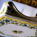 Hand-painted flat dish decorated in the Moustier style.