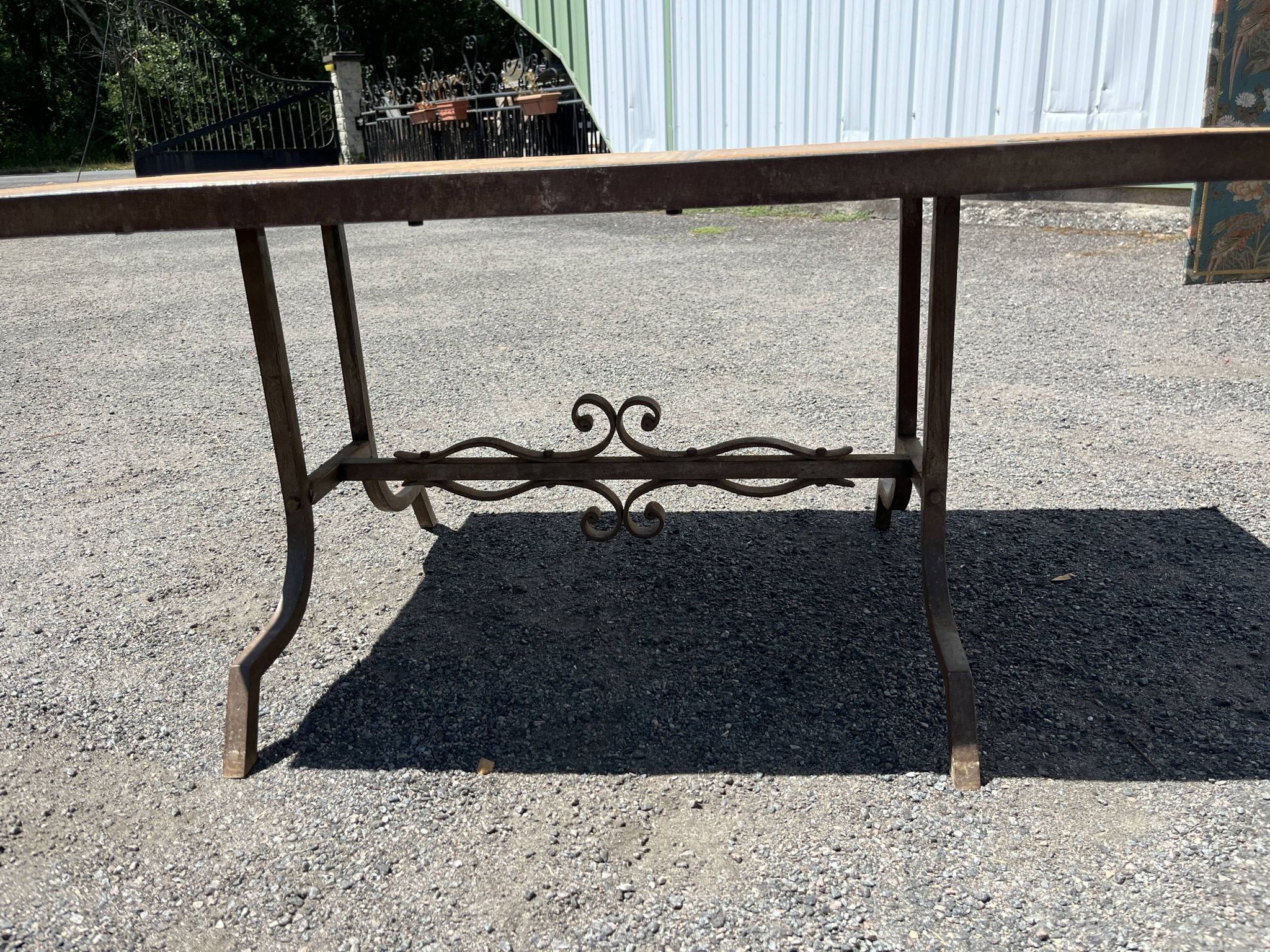 Vintage garden table with ceramic tile top and wrought iron base