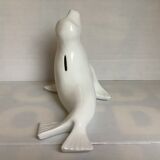 White earthenware sea lion in piggy bank