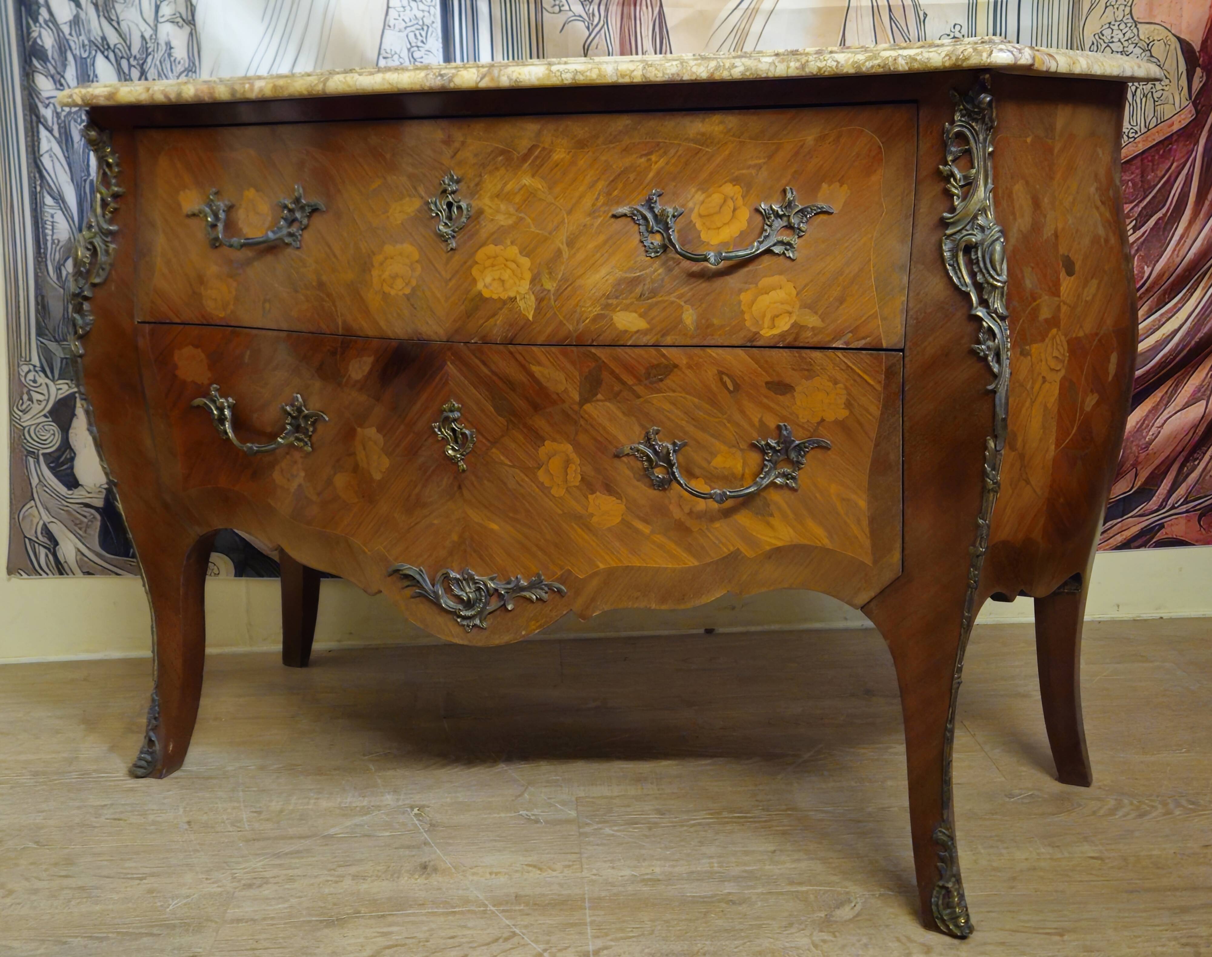Curved Louis XV style commode with floral marquetry and marble top.